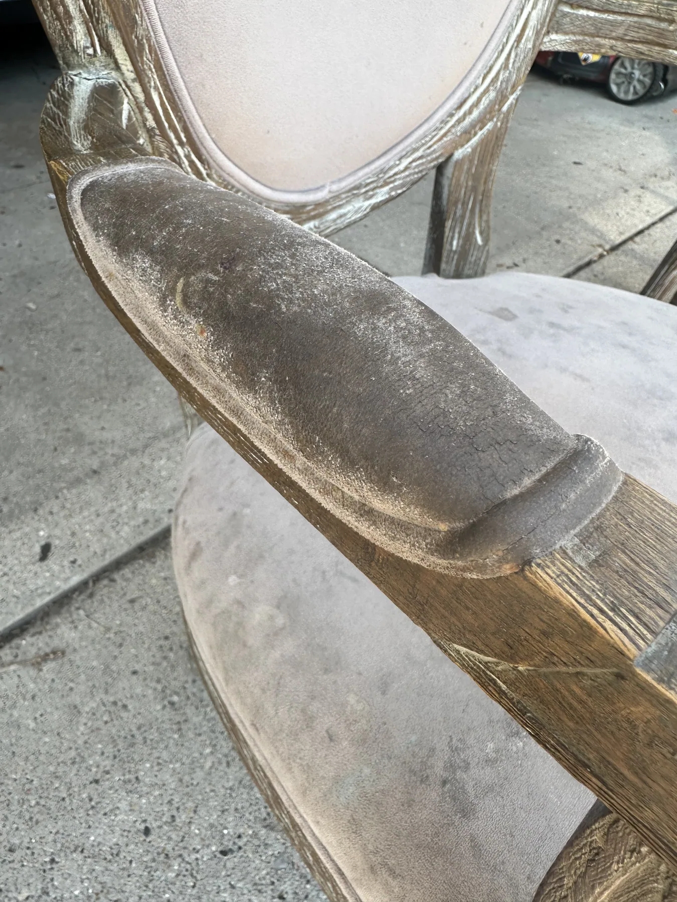 Close-up of a dirty upholstered chair armrest before dry cleaning