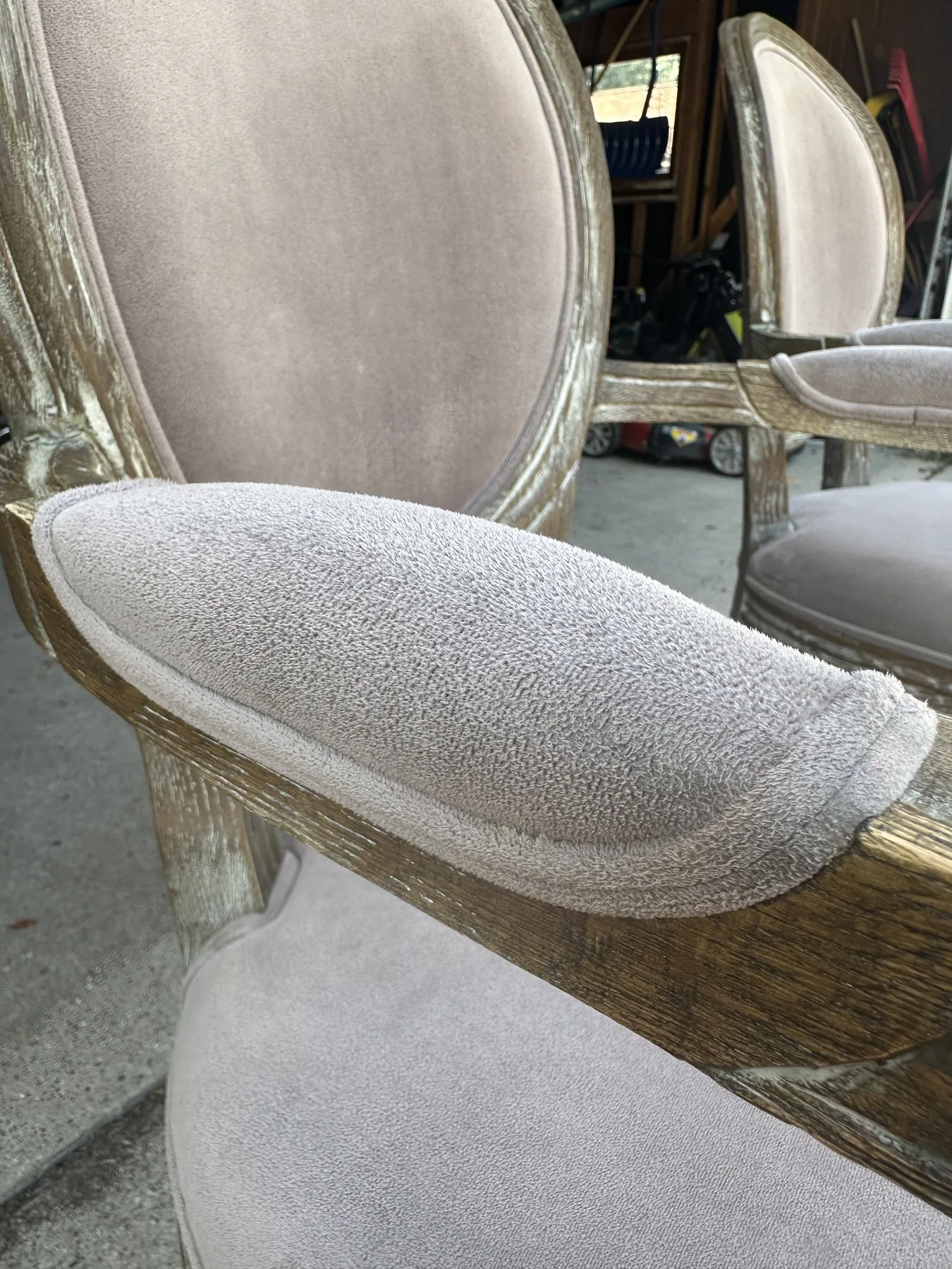 Close-up of a clean upholstered chair armrest after dry cleaning, velvet nap restored