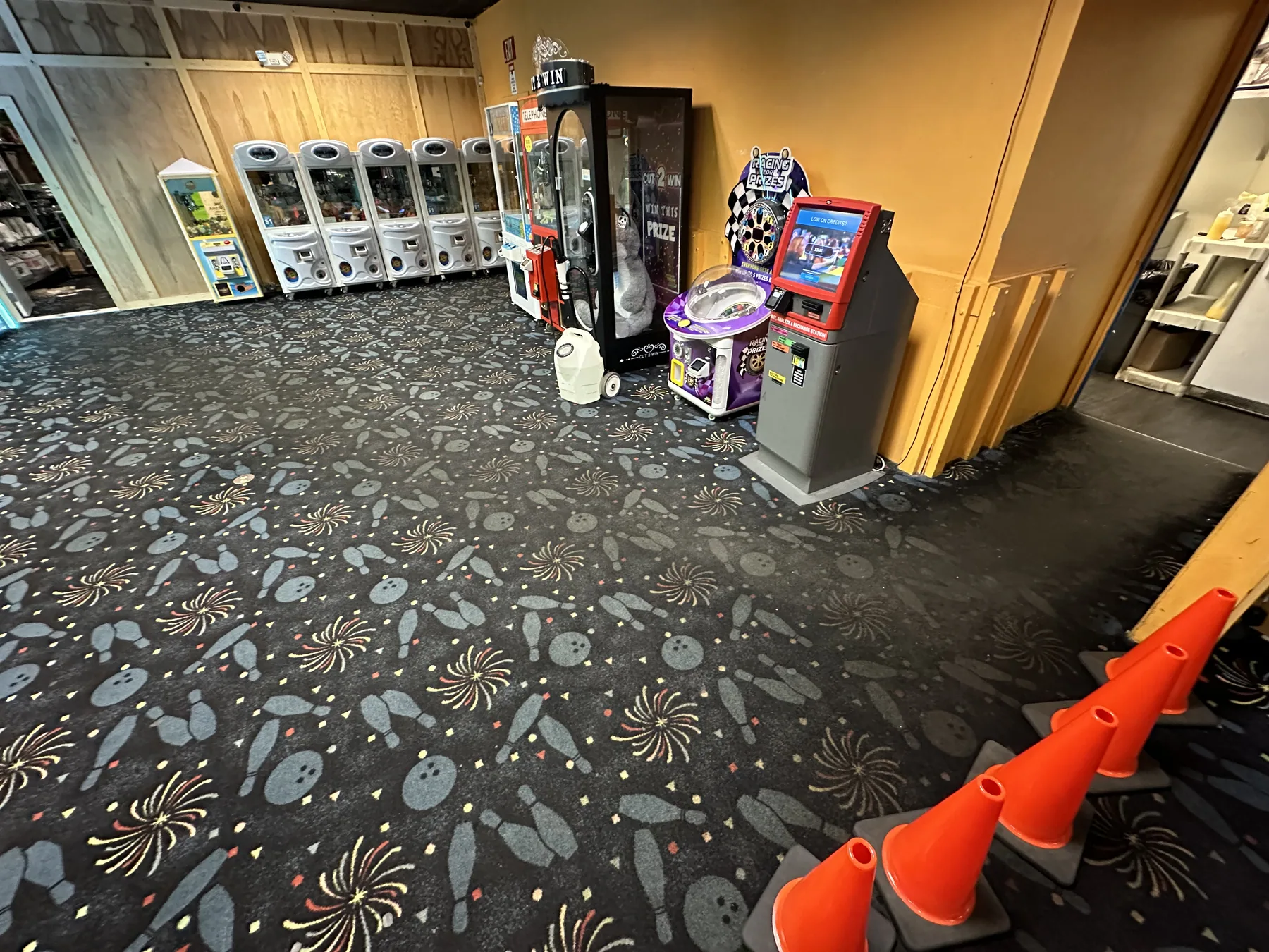 Patterned commercial carpet cleaned in an arcade and family entertainment center, arcade cabinets visible