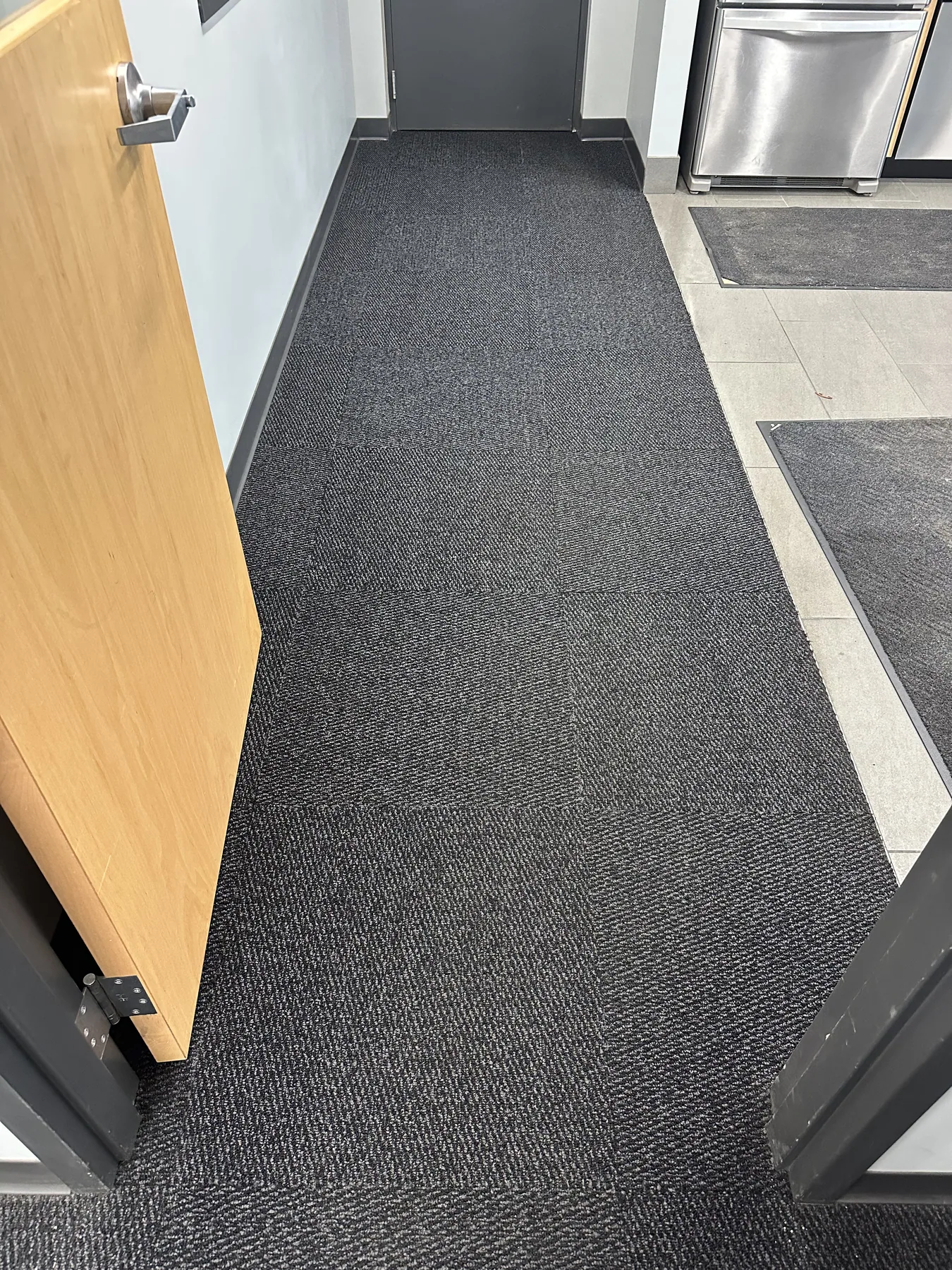 Same commercial kitchen hallway carpet restored to even color after dry cleaning