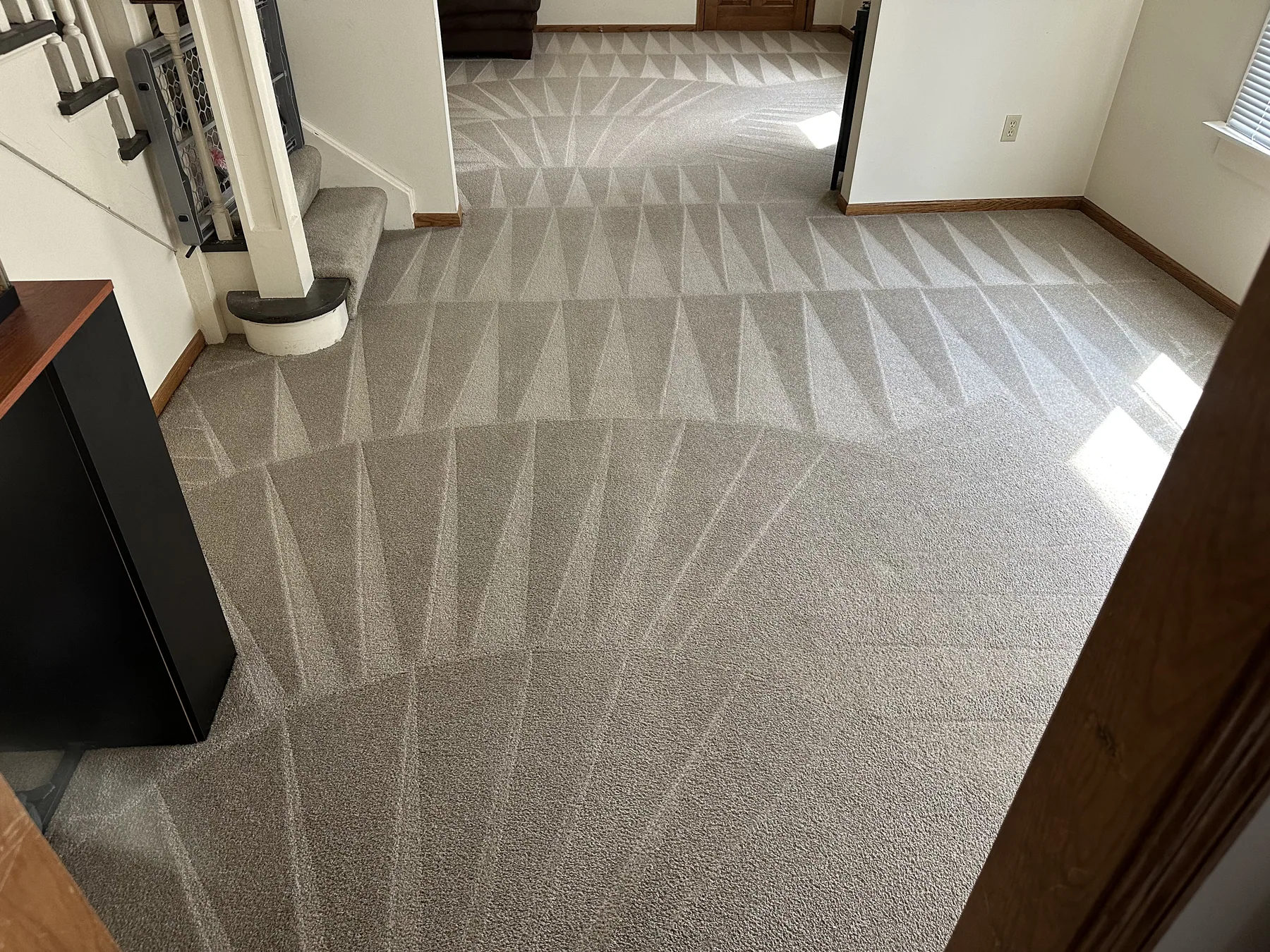 Staircase with a fan-pattern vacuum finish left after carpet dry cleaning
