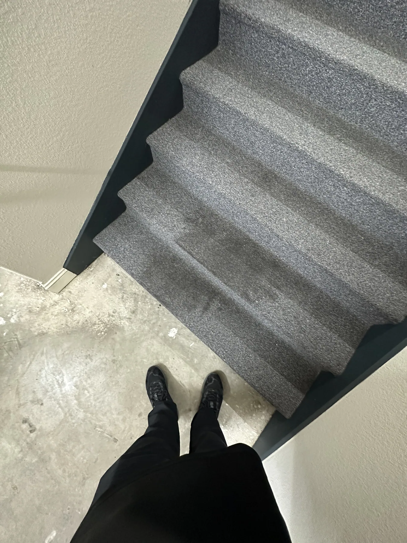 Stairwell landing carpet with visible ground-in soil before cleaning