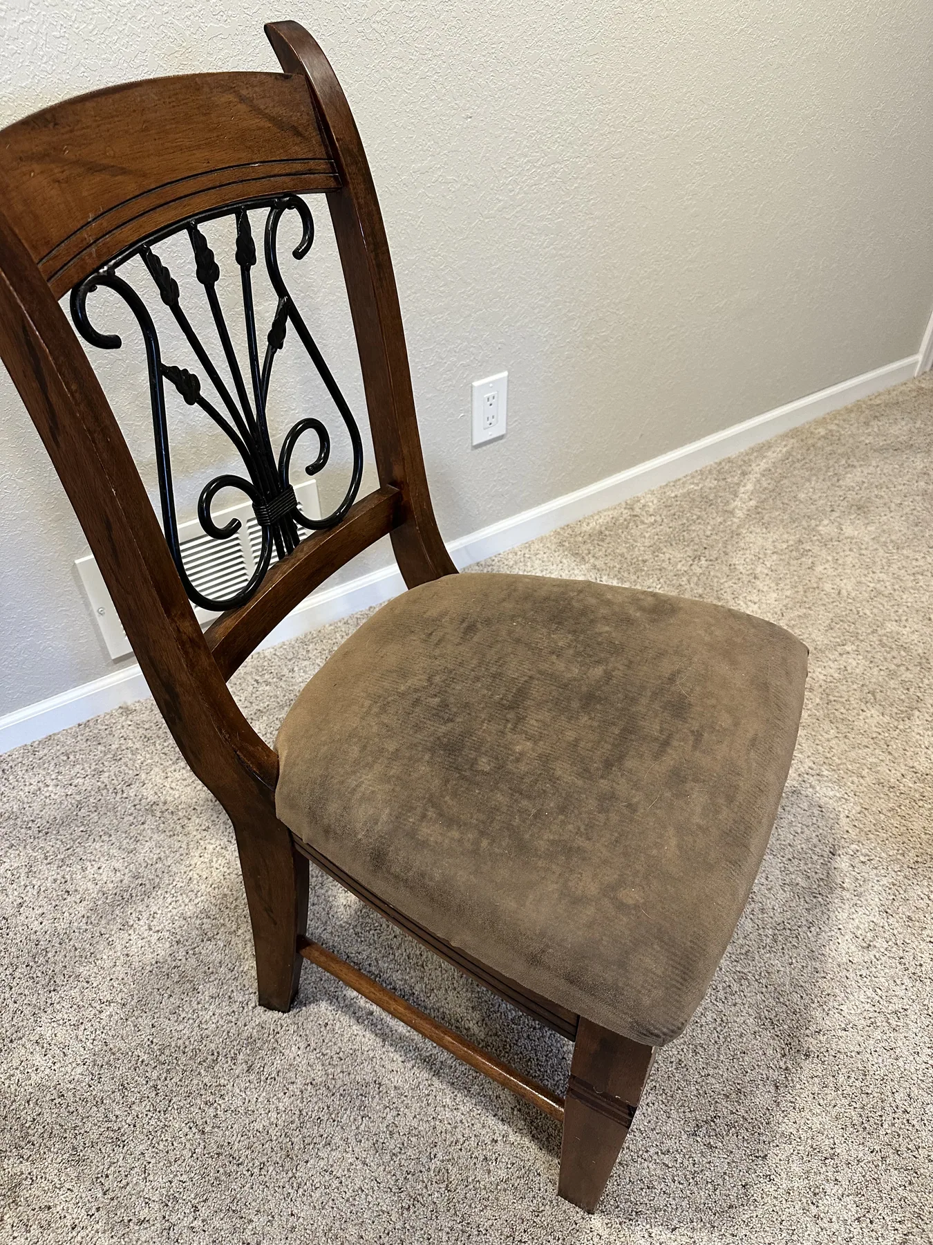 Wood-frame dining chair with soiled fabric seat before cleaning