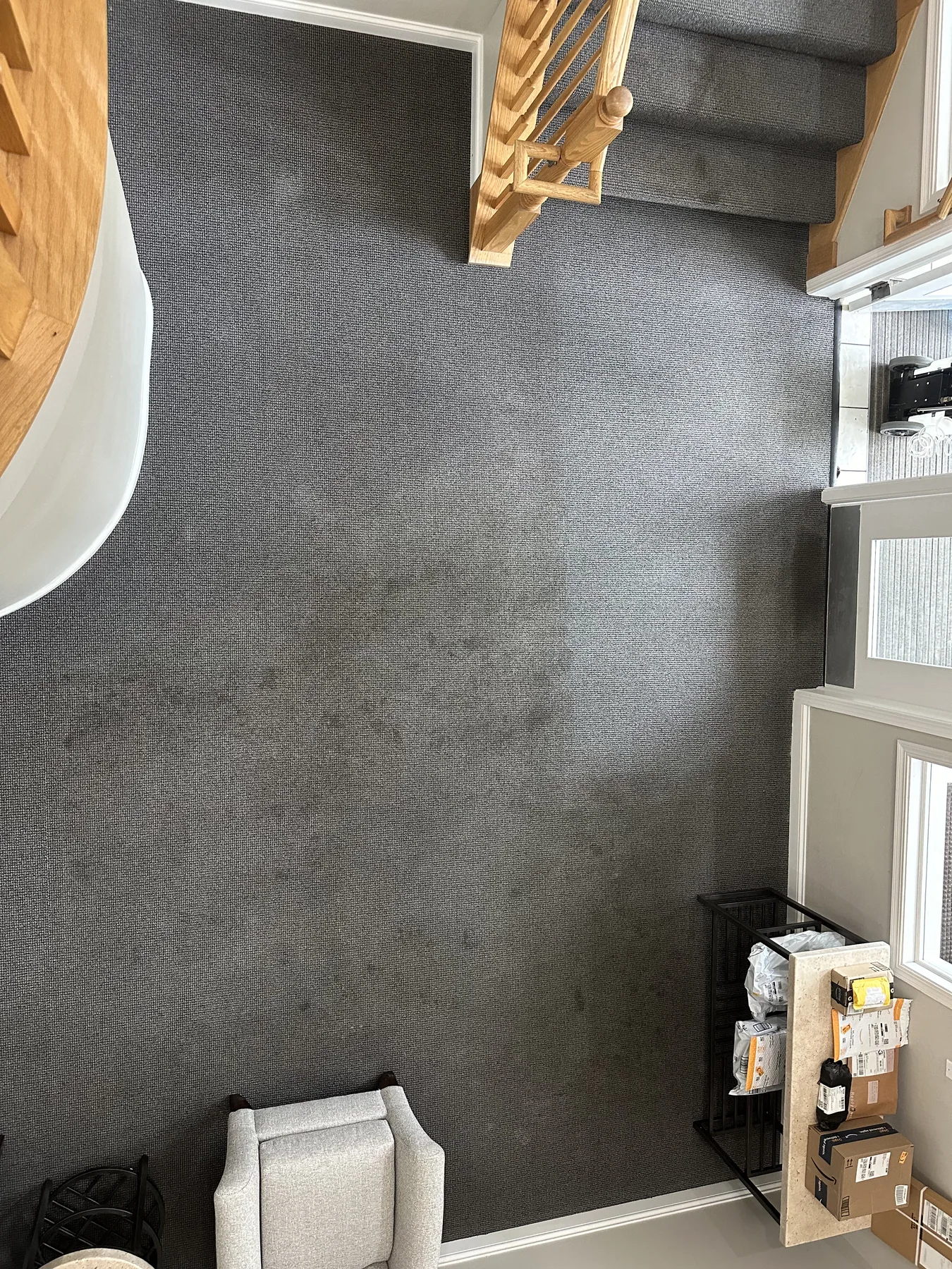 Open room off a stairwell landing with visibly soiled carpet before cleaning