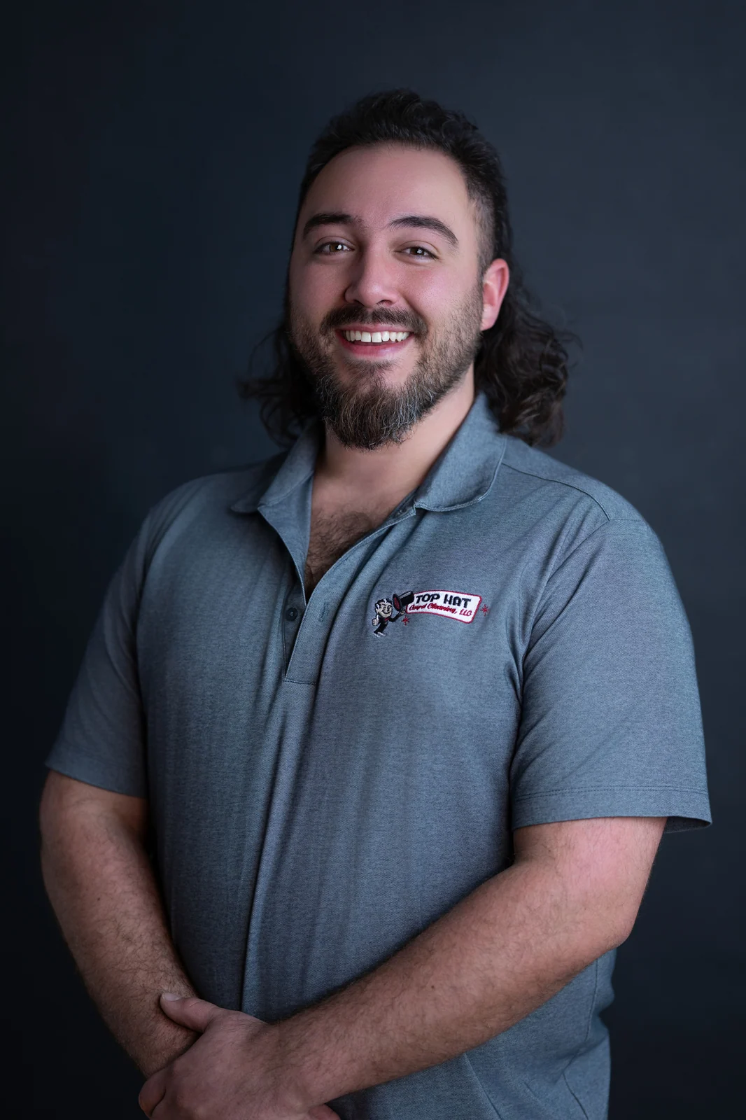 Tim Lazaris, owner of Top Hat Carpet Cleaning, in a grey Top Hat branded polo